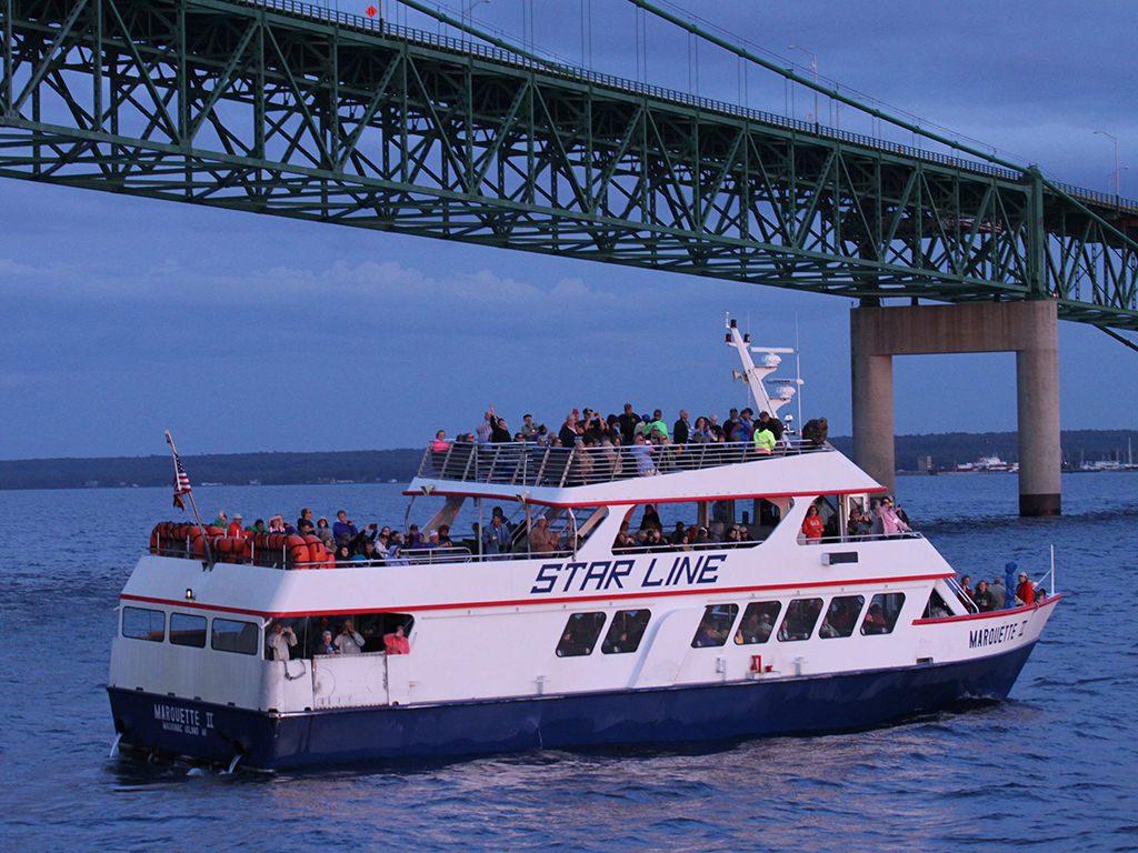 Star Line ferry under mackinac bridge headed to the island