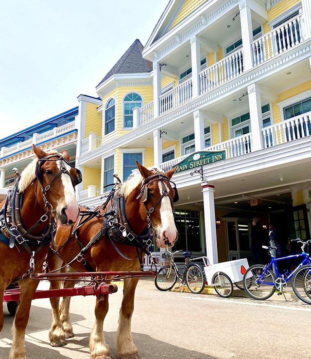 Main Street Inn & Suites exterior with horse and carriage in front